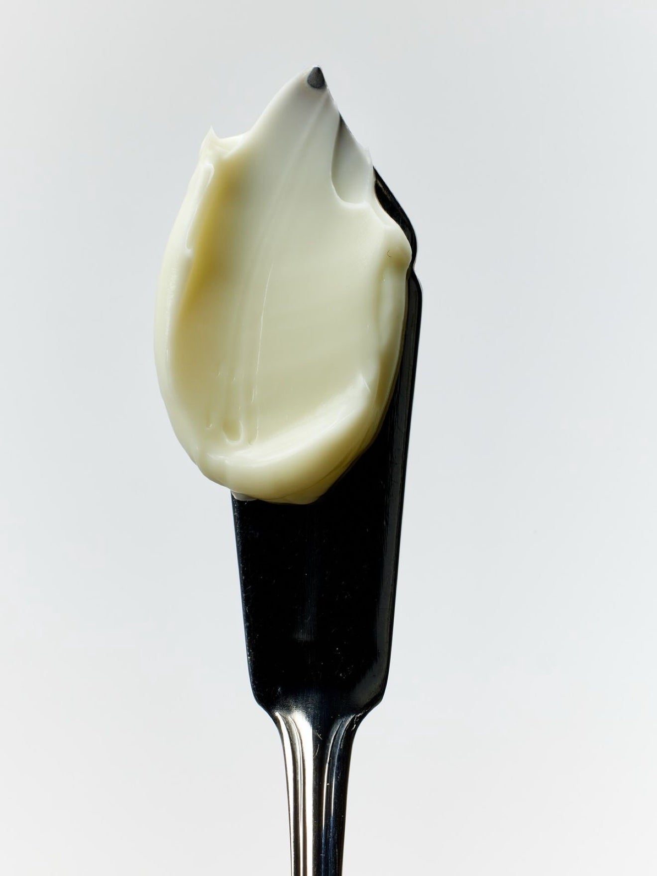 A swatch of MelaBODY Face Cream on a black spatula